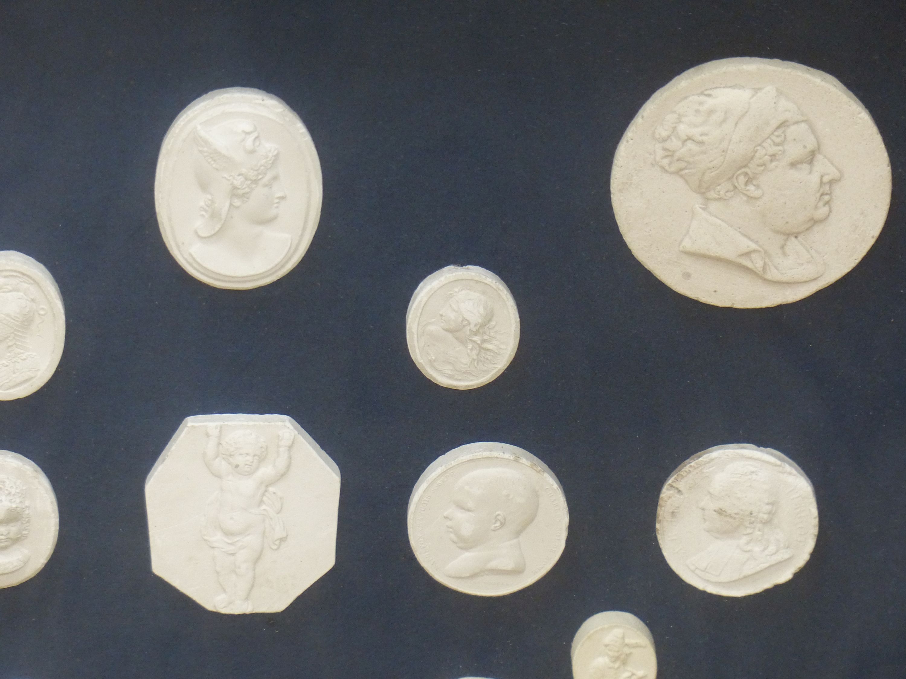 A framed set of Italian plaster cameos